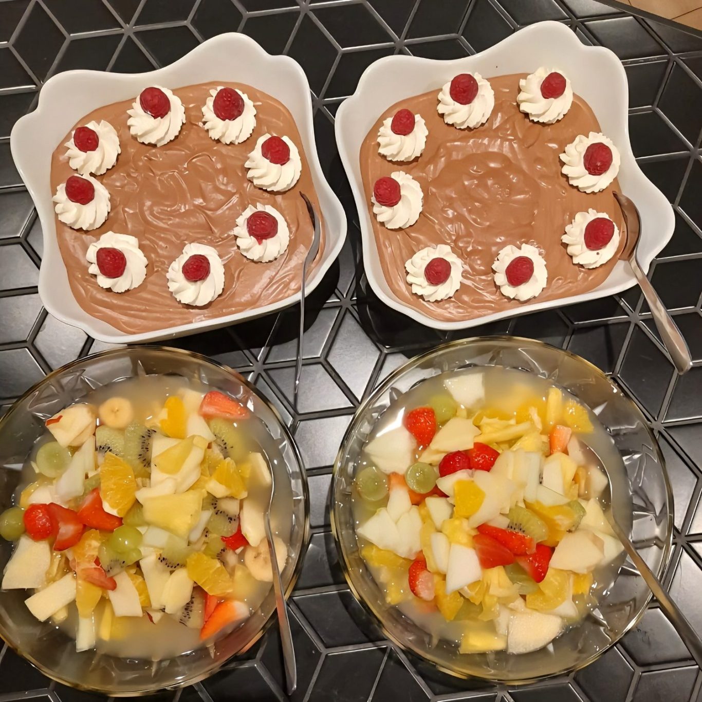 Frischer Obstsalat und cremige Desserts mit verschiedenen Früchten – bunte Vielfalt aus frischen Zutaten